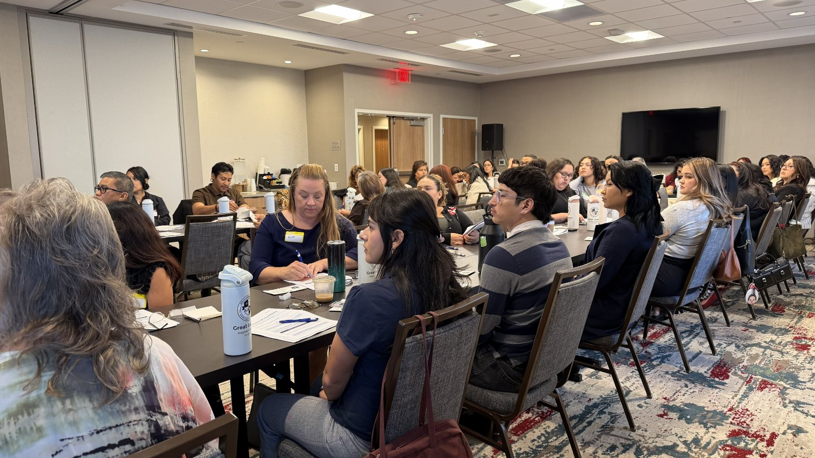 A full room of AVPH staff listening during the Leadership Academy closing seminar