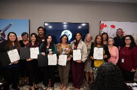 A group of Leadership Academy graduates posing with their certificates