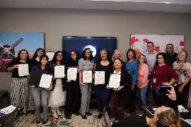 Graduates celebrating with their Leadership Academy certificates